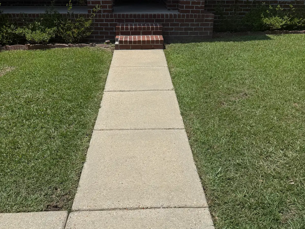 The same walkway bright and clean after pressure washing